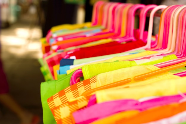 Clothes hang on a shelf.