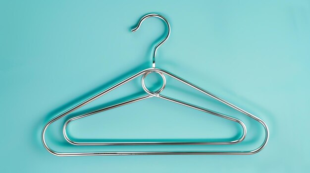 Clothes hanger isolated on a blue background Simple and minimalistic fashion concept