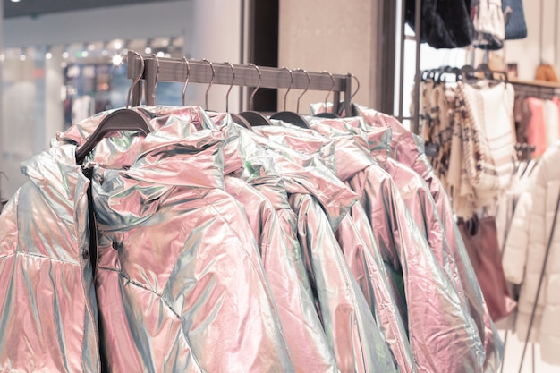 Clothes on hangers in a fashion store.