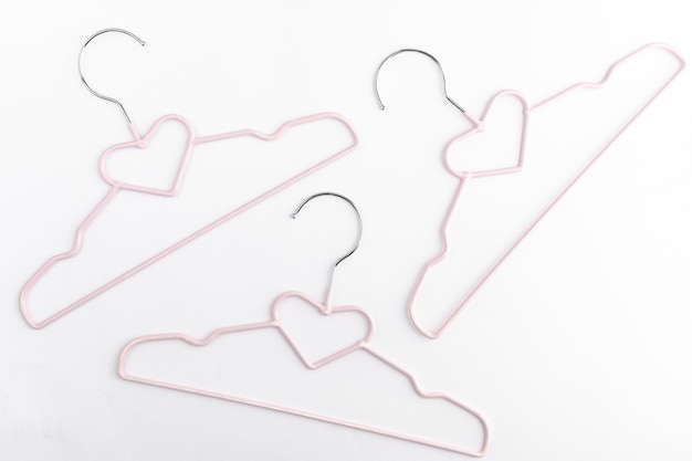 Clothes hangers on a white background. the concept of shopping, buying clothes, discounts, sales, stylist. Top view