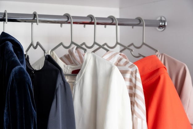 Clothes hanging on a clothes rack in a store or home closet