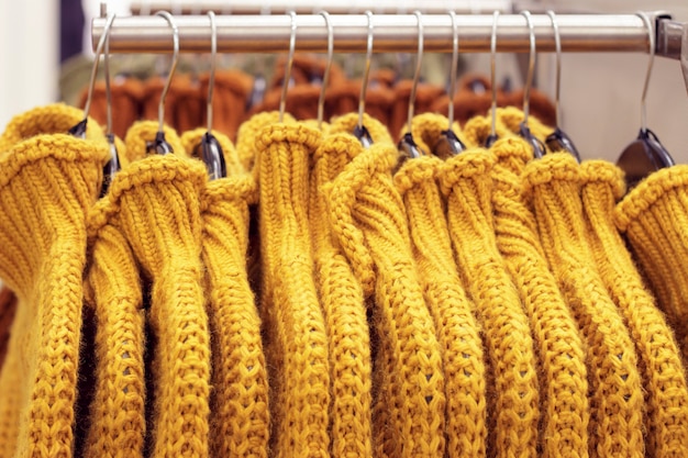 Clothes hanging on hangers in the store, choice of clothing concept