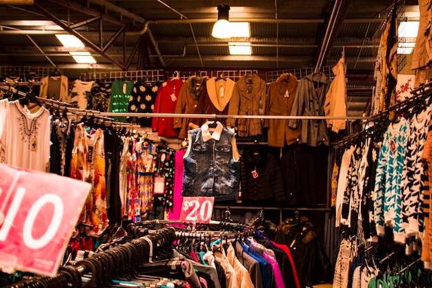 Photo clothes hanging in store for sale at market