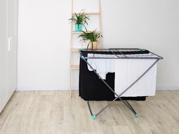 Clothes hanging on tumble dryer in room scandinavian interior