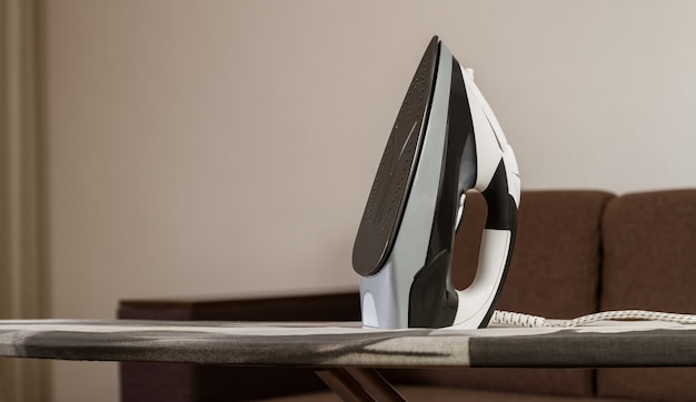 clothes iron on ironing board