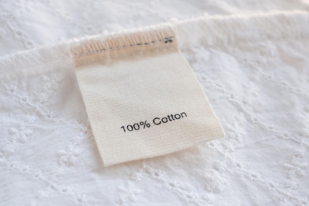 Clothes label on cotton fabric texture background