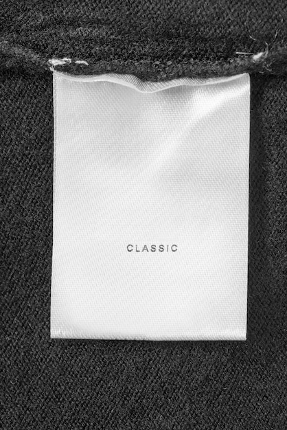 Clothes label says classic on black knit wool fabric closeup