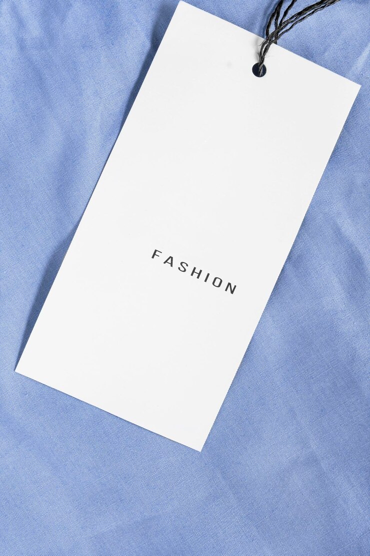Photo clothes label says fashion on blue cotton fabric backtround