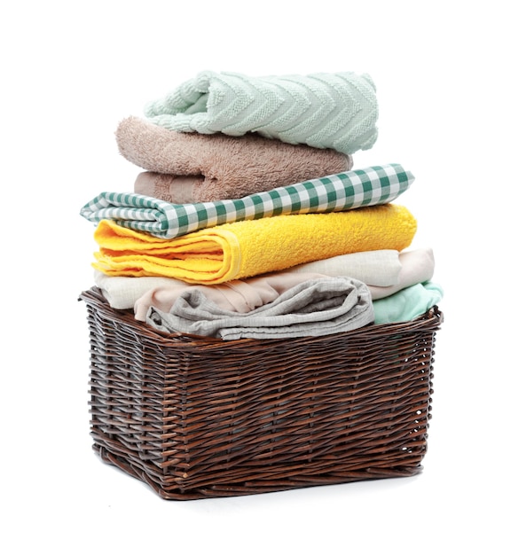 Photo clothes in a laundry wooden basket isolated on white background