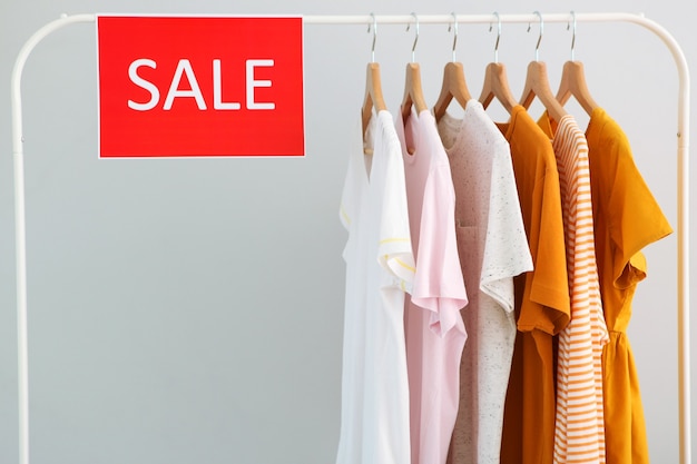 Premium Photo  Clothes on the rail and a sale sign final sale discounts