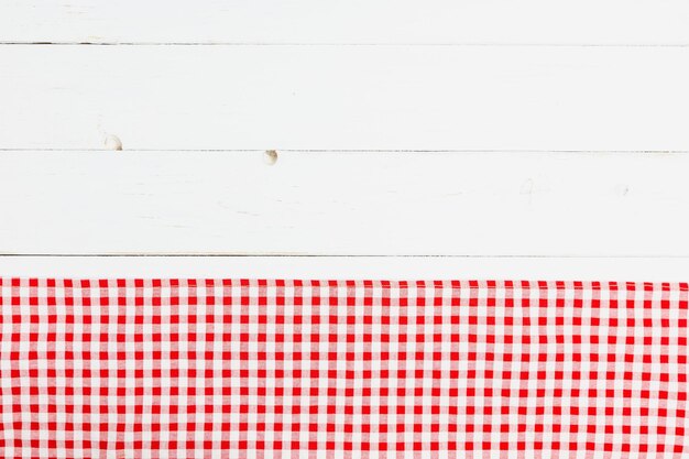 Photo clothes red and white on white background for a menu of a restaurant with copy space top view fabric tablecloth on old white wood background flat lay checked fabric old wooden