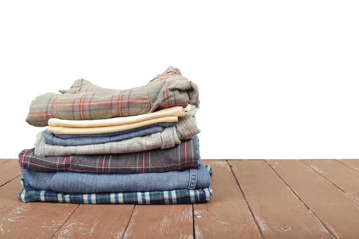 Photo clothes shoes and accessories group stack pile of colorfull jeans wooden and white background