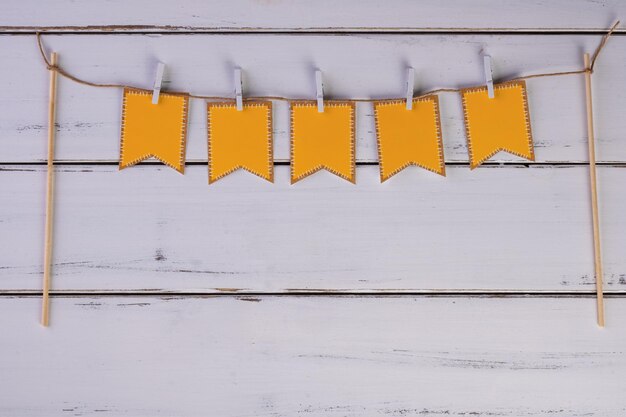 Clothesline with party flags on white wooden table