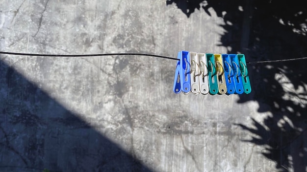 clothespins attached to stretched clothesline from wire