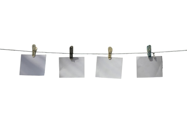 Ключи для одежды и пустые бумаги, висящие на веревке на белом фоне
