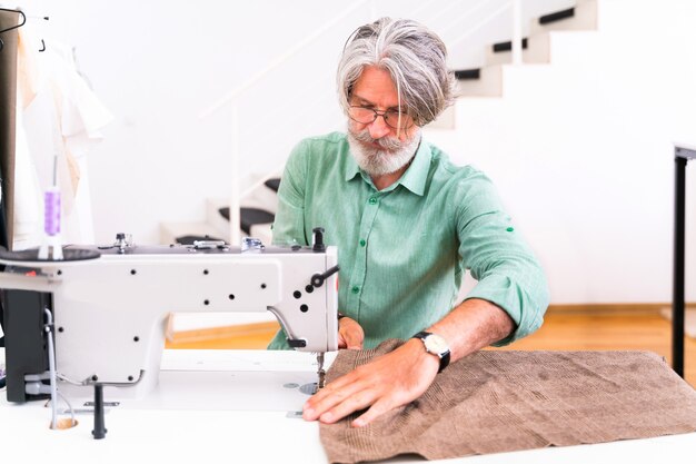 Clothing stylist creating a new design for a dress - Fashion designer working on a clothing brand in a textile factory