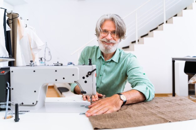 Clothing stylist creating a new design for a dress - Fashion designer working on a clothing brand in a textile factory