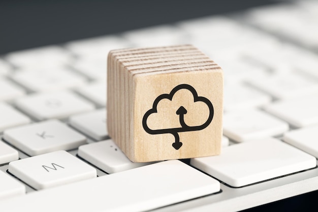 Cloud computing icon on wooden block on computer keyboard