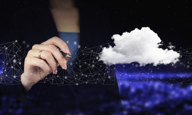 Photo cloud computing technology internet concept background. hand holding digital graphic pen and drawing digital hologram cloud sign on city dark blurred background.