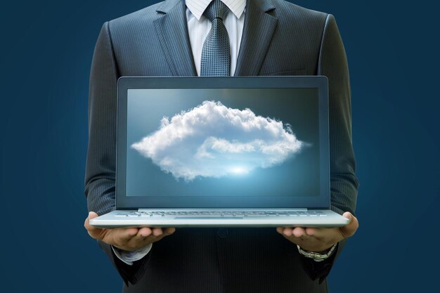 Cloud data in the laptop businessman on a blue background