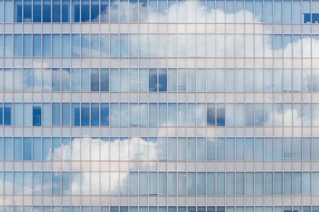 Cloud reflected in windows of modern office building