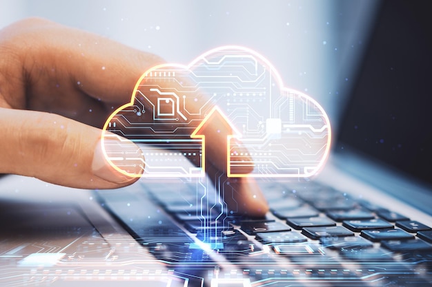 Cloud service and technologies concept with digital cloud symbol with arrow and circuit inside on human fingers typing on modern laptop keyboard background double exposure