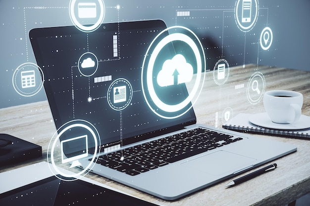 Cloud service technology concept with digital data storage icons and opened laptop with coffee cup on background