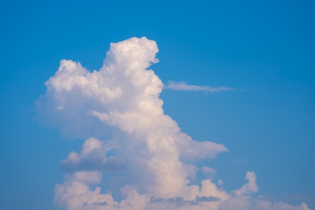 A cloud in the sky with a blue sky in the background.