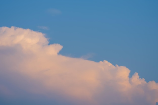 A cloud in the sky with the moon in the background