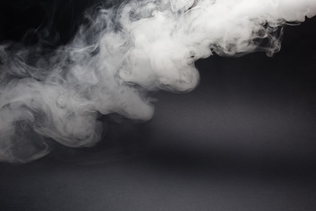 Cloud of white smoke on black closeup