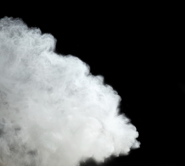 Cloud of white wheat flour on black