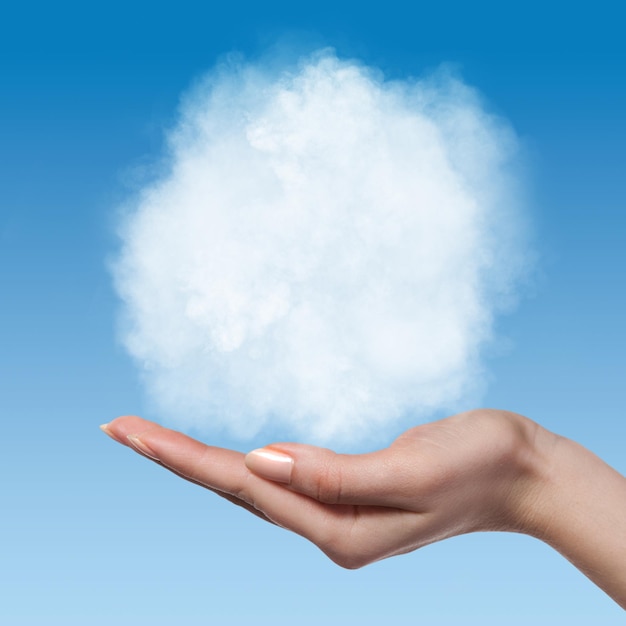 Cloud in woman hands on blue sky