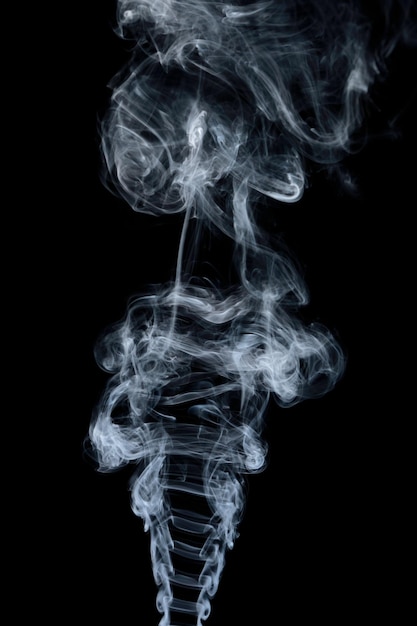 Clouds of curls of smoke on a black background.