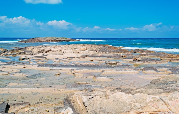 Clouds over Is Arutas rocky coastline