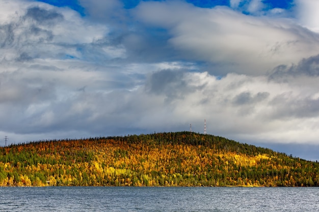 Clouds over the lake in the mountainous part of the tundra in autumn.