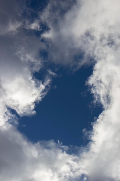 The clouds parted and formed a hole and showed the blue sky