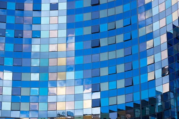 Clouds reflected in windows of modern office building