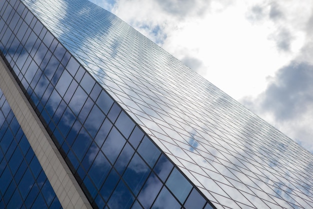 Clouds reflected in windows of modern office building