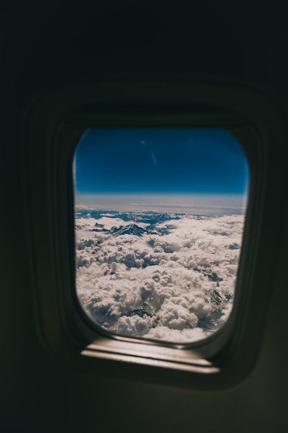 航空機の窓を通して見える雲と空