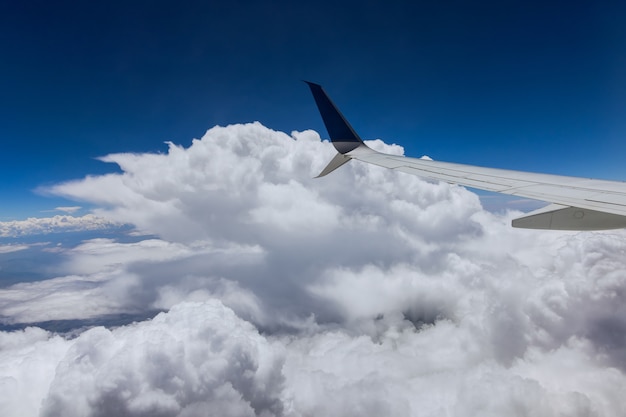 Clouds in the sky as seen on a wing of an airplane flying