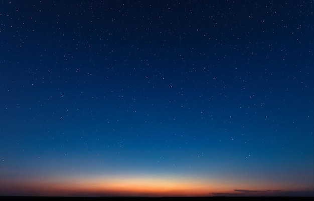 Photo clouds and stars in the blue night sky