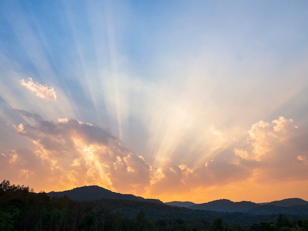 Clouds and sunbeam over the mountain in evening.