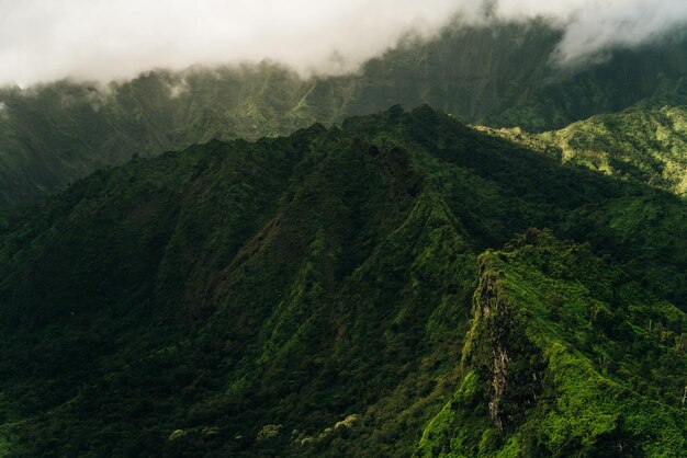 Clouds swirling around mountains of kauai as seen from helicopter
