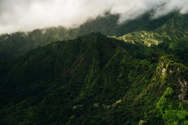 Clouds swirling around mountains of kauai as seen from helicopter