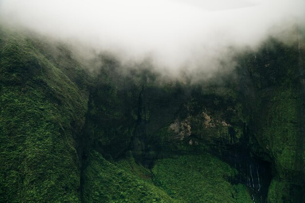 Clouds swirling around mountains of kauai as seen from helicopter