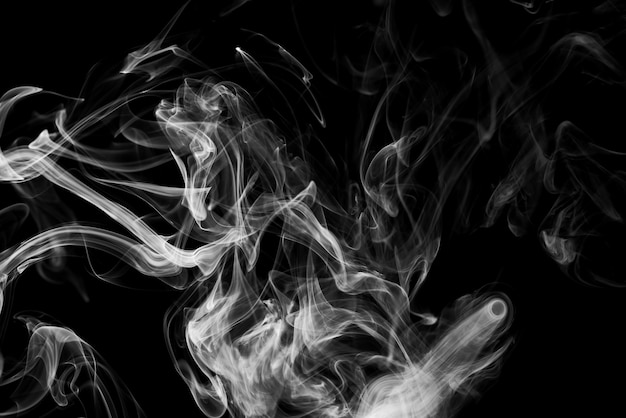 Clouds of white smoke on a black background