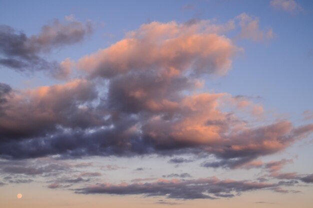 Cloudscape, colored clouds at sunset near the ocean