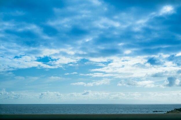 Cloudy blue sky and horizon over the water in Tenerife island, Atlantic ocean.