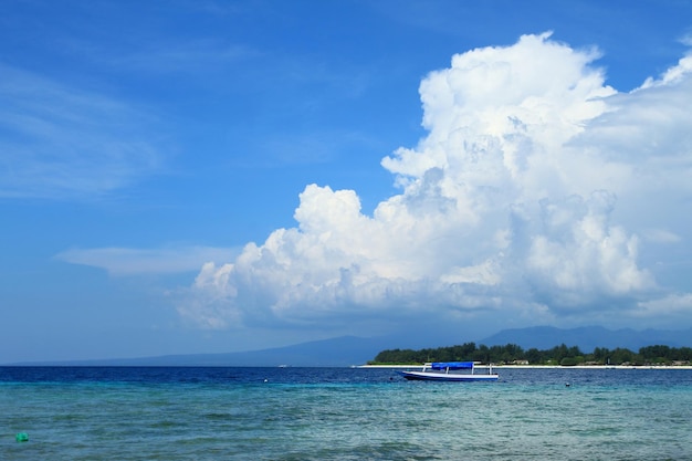 Cloudy blue sky above the turquoise sea at Gili Trawangan, Indonesia.