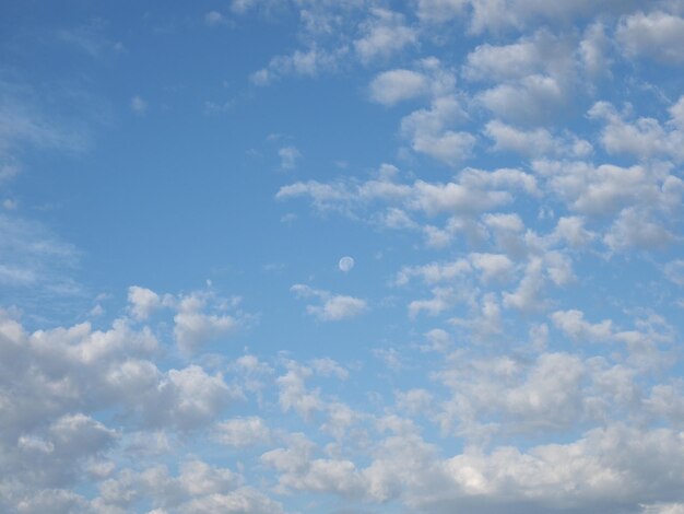 写真 月の背景に曇りの青い空